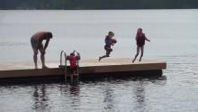 Kids jumping into lake